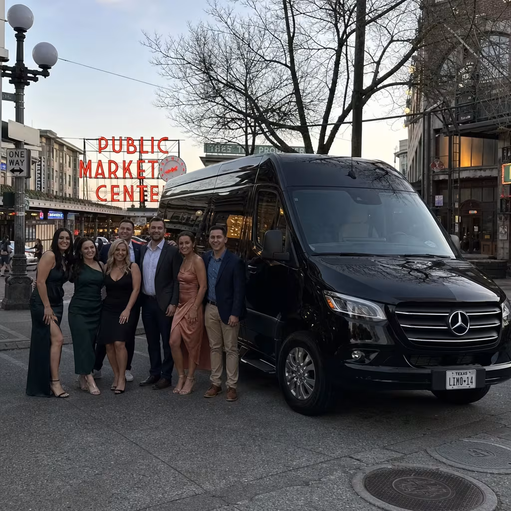 Group beside a Mercedes Sprinter limo from the Portland fleet at the beach